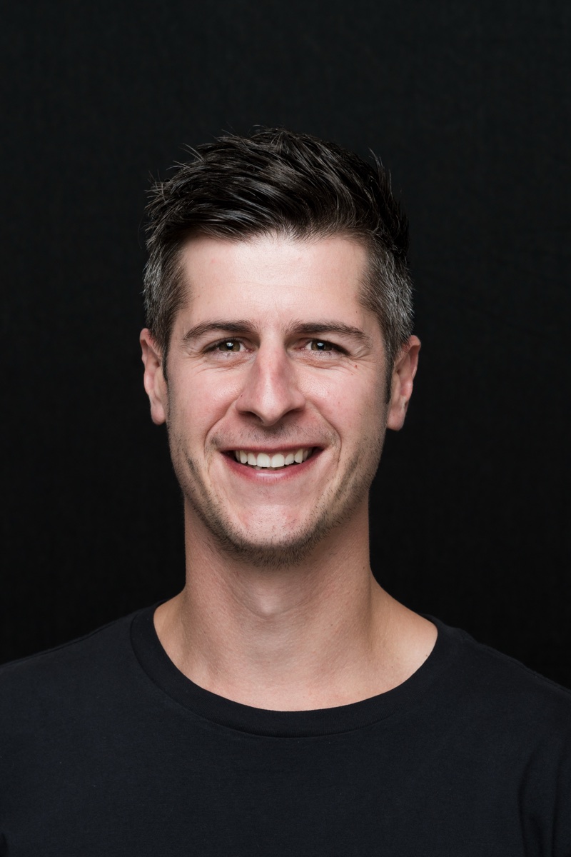 Studio headshot of Matt Budden smiling